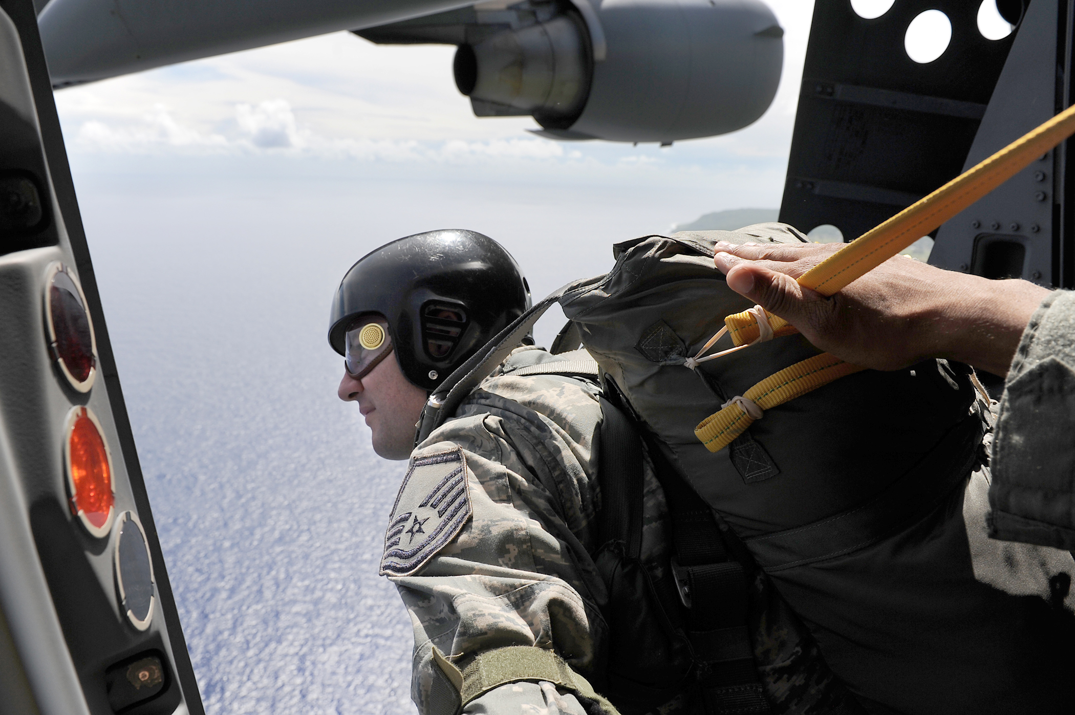 This is an image of a service member about to parachute out of an aircraft.